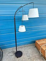 Full view of floor lamp showing base, post, and three shades