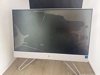 Front view of HP all-in-one showing cracked screen and stand