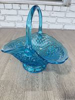 Full view of blue pressed glass basket showing shape, handle and color