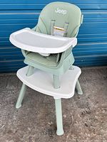 Front view of Jeep green high chair with white tray