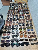 Full table view showing 100 pairs of assorted sunglasses