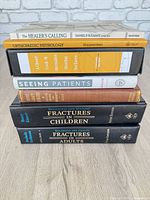 Stack of seven medical textbooks