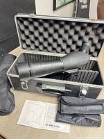 Scope in hard case with accessories visible