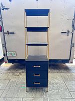 Full view front of shelving unit showing frame, shelves, drawers