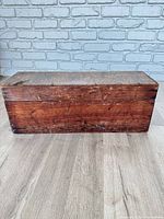 front view of closed wooden box showing wood grain and wear