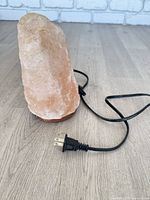 Front view of Himalayan salt lamp showing cord and plug