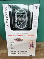 Front of sealed Sharper Image Gravity Rover box showing product and branding