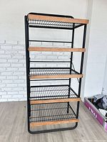 Full front view of metal shelf showing five tiers