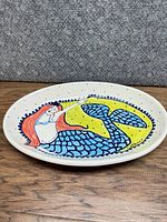 Top view of oval serving dish with mermaid artwork