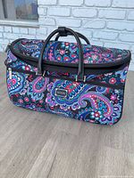 Full view of rolling duffel bag showing pattern, handles and shape
