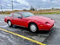Driver side exterior profile of red 1988 Nissan 300ZX Turbo in parking lot