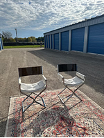 Frontal view of both chrome director chairs on rug