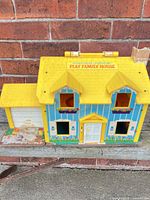 Front exterior of Fisher-Price Play Family House with attached garage