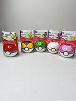 Front view of all five sealed Pokeball sets