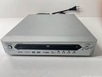 Front view of Daytek DVK2001S showing disc tray, control buttons and format logos