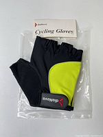 Front view of gloves showing yellow panel and logo strap in packaging