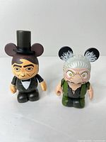 Front view of both Disney Vinylmation chaser figures