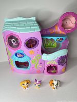Exterior of closed purple playset with three figures in front