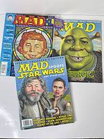 Front covers of all three Mad magazines displayed