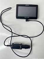 Front view of GPS unit with attached car charger cable