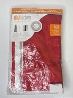 Front of sealed package showing brand and red apron inside