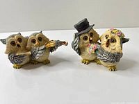 Both owl figurines side by side on white background