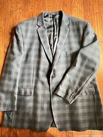 Front view of grey plaid wool sport coat laid flat