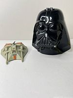 Darth Vader helmet and Snowspeeder side by side