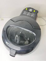Top view of fryer showing transparent lid and control panel