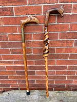 Both walking sticks full length against wall