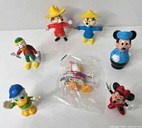 Group shot of all seven figures including sealed Webby bag