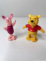 Front view of Winnie the Pooh and Piglet PVC figurines