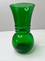 front view of green glass vase showing flared neck and rounded base