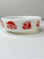 Side view showing clown graphics and milk glass material