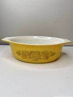 Side view showing yellow body, gold Rosette pattern, handles