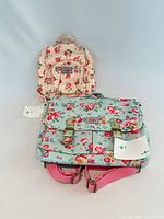 Front view showing both backpacks, floral patterns and brand patches