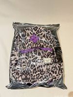 Backpack in factory plastic showing full front and packaging