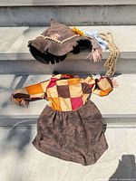 Front view of scarecrow dress and hat showing overall design and accessories