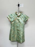 Front view of children’s qipao dress on hanger