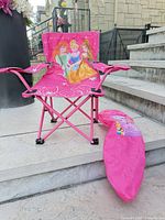 Front view of folded-out Disney Princess chair and carry bag