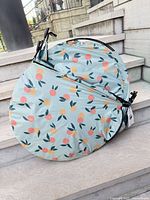 Tent folded inside printed circular carry bag