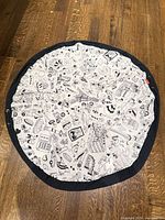 Play mat laid out flat showing full pattern and black edge