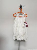Front view of white Biscotti dress on hanger