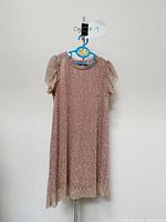 front view of Dex rose gold metallic dress on hanger