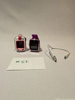 Front view of both smartwatches and charging cable