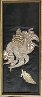 Full framed view of black textile with gold embroidered turtles and waves
