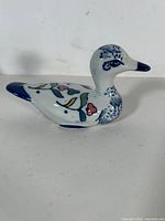 Left side view of blue and white porcelain duck figurine