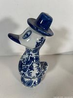 front left view of blue-white porcelain duck figurine with hat