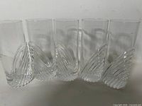 Five crystal tumblers front view showing swirl bases