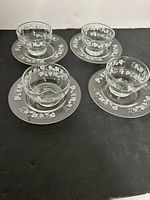 Set of four bowls on saucers showing full set